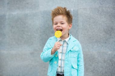 Lolipop gri duvarının yakınında olan moda çocuk