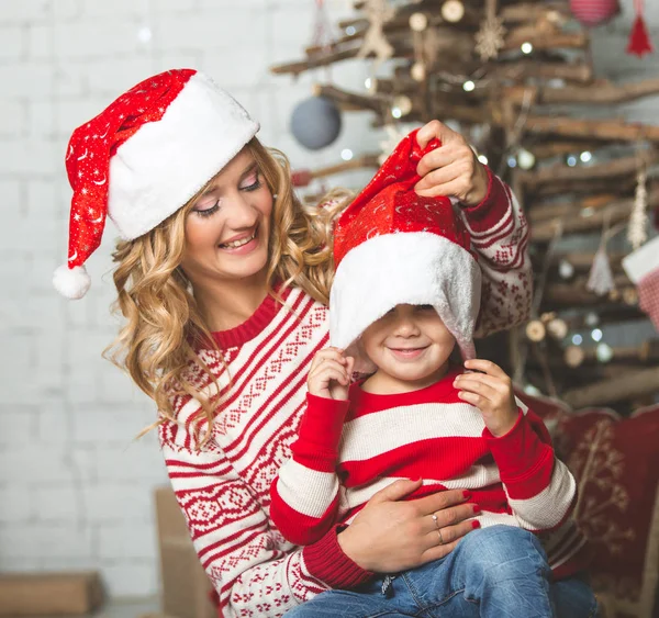 Portrait of happy mother and son on the background of the Christmas tree in new year room. The idea for postcards — Stock Photo, Image