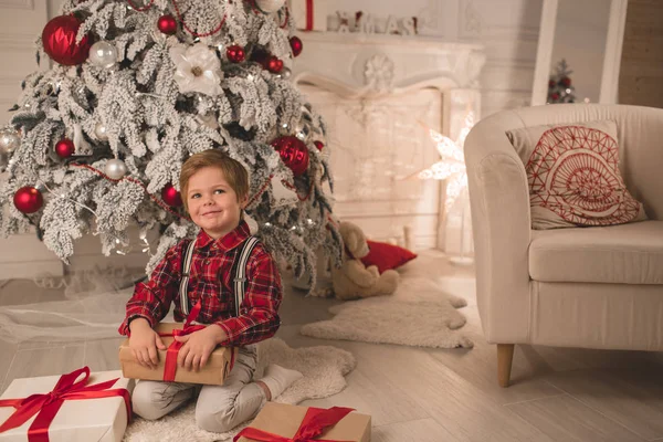 Young boy at home on Christmas evening — Stock Photo, Image