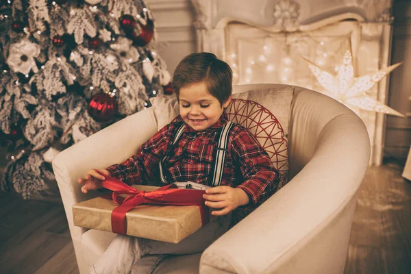 Young boy at home on Christmas evening — Stock Photo, Image