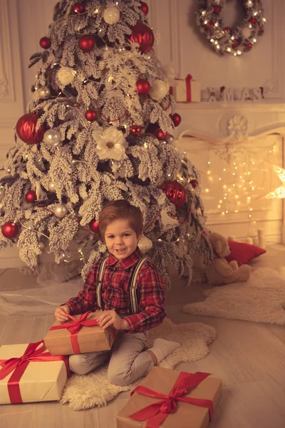 Young boy at home on Christmas evening — Stock Photo, Image