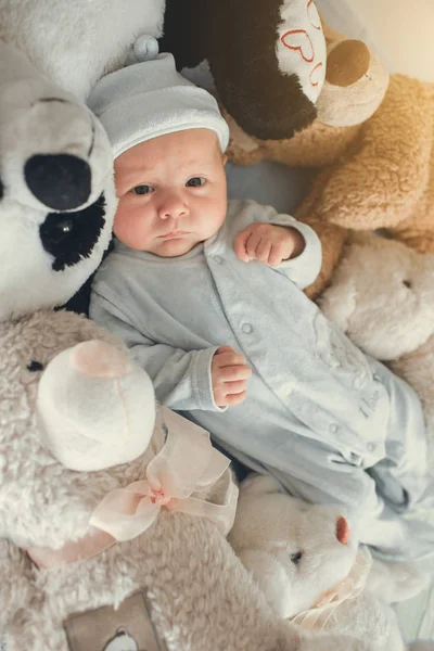 Newborn baby laying with five teddy bears on blanket — Stock Photo, Image