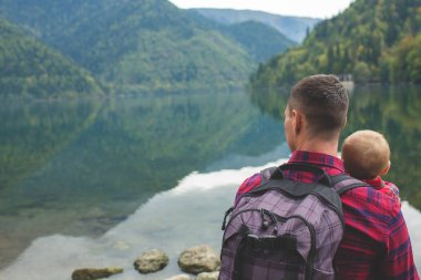 Dad and son walk by the lake
