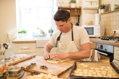 Young man bakes cookies