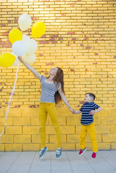 Piccolo ragazzo e la sua mamma posa contro il muro — Foto Stock