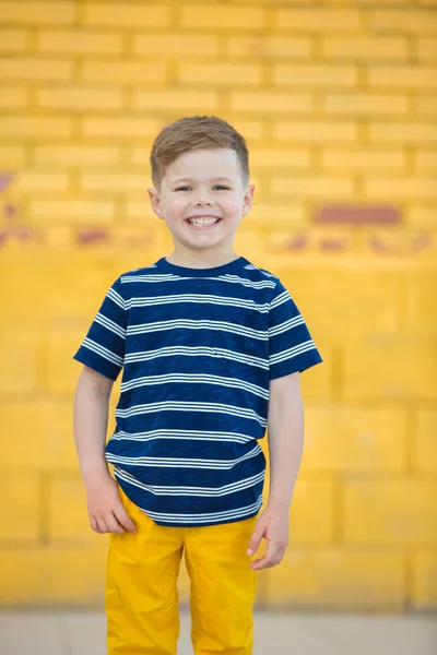 Little boy posing against the wall — Stok fotoğraf