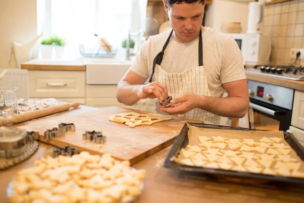 Young man bakes cookies