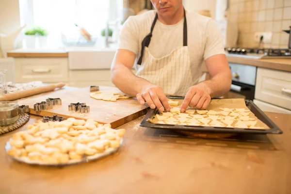 Young man bakes cookies