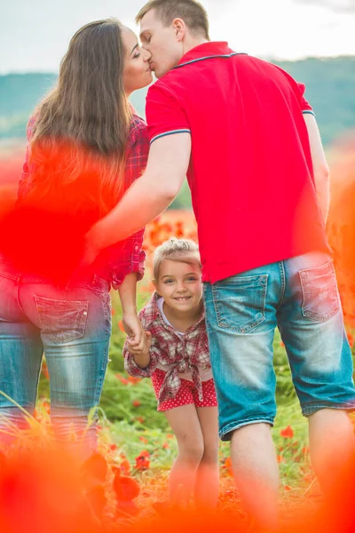 Woman her husband and their daughter in poppy field — ストック写真