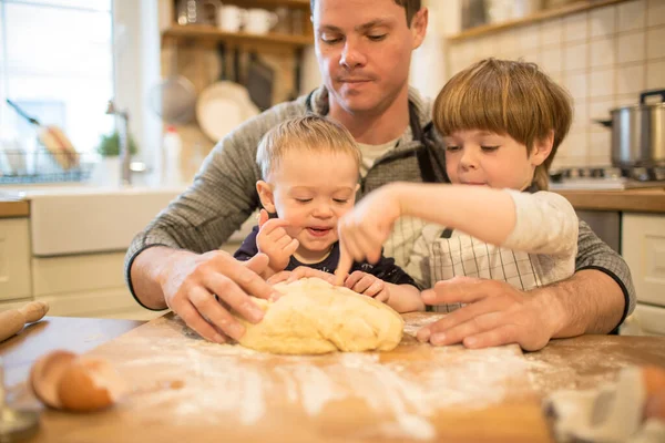 Pai e filhos fazem biscoitos — Fotografia de Stock