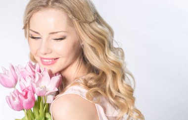 Luxurious blonde with a bouquet of tulips