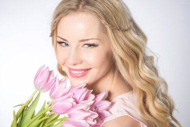 Luxurious blonde with a bouquet of tulips