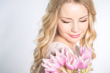 Luxurious blonde with a bouquet of tulips