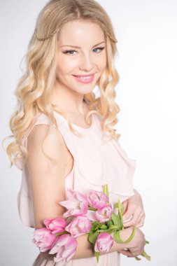 Luxurious blonde with a bouquet of tulips