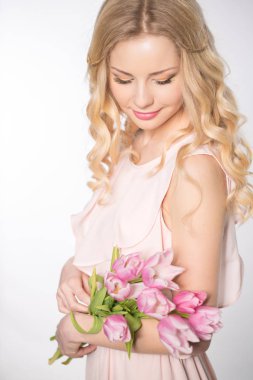 Luxurious blonde with a bouquet of tulips