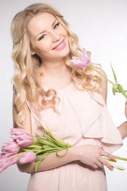 Luxurious blonde with a bouquet of tulips