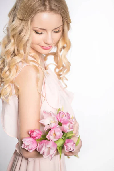 Luxuriöse Blondine mit einem Strauß Tulpen — Stockfoto