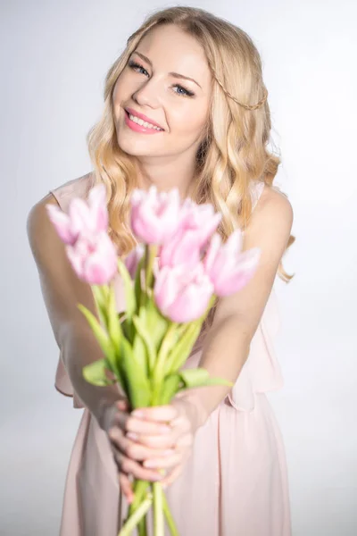 Luxurious blonde with a bouquet of tulips — Stok fotoğraf