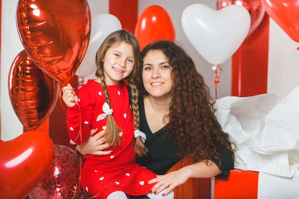 Mom and daughter with red and white balloons — 스톡 사진