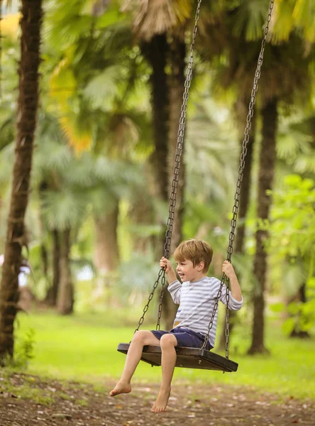 Teen boy on swing — Stock Photo, Image