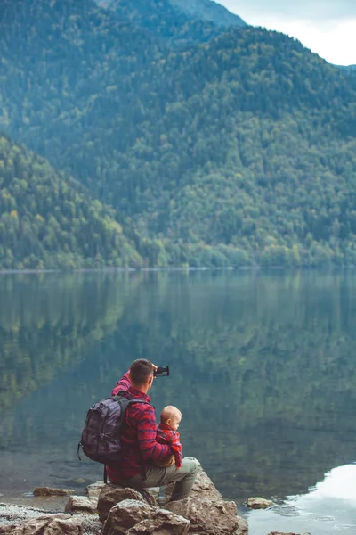 Papa et fils marchent au bord du lac — Photo