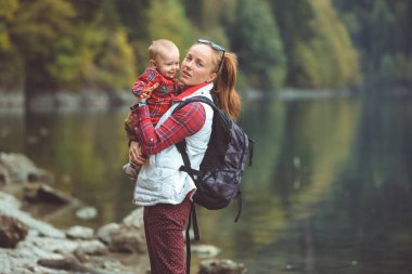 Mom and son walk by the lake