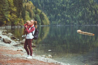 Mom and son walk by the lake