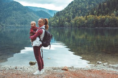 Mom and son walk by the lake