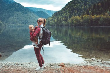 Mom and son walk by the lake