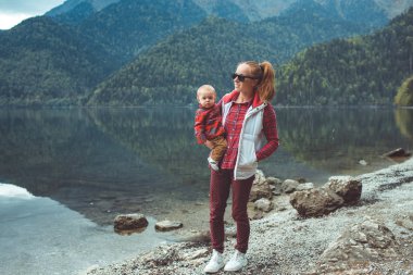 Mom and son walk by the lake