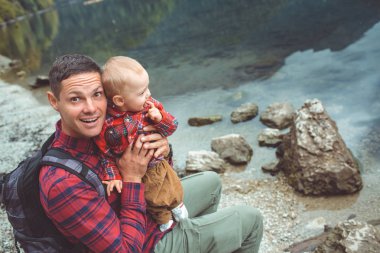 Dad and son walk by the lake