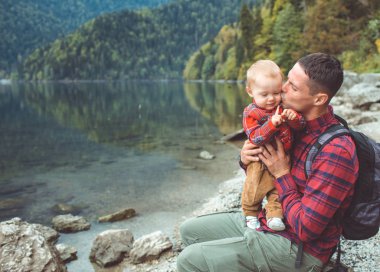 Dad and son walk by the lake