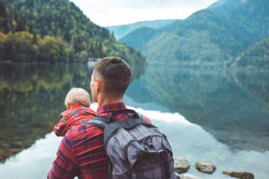 Dad and son walk by the lake