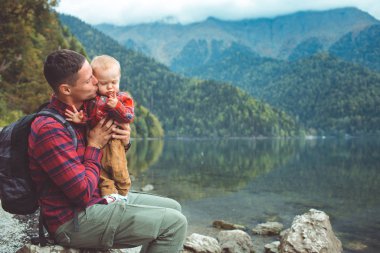 Dad and son walk by the lake