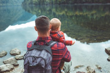 Dad and son walk by the lake