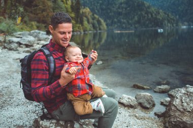 Dad and son walk by the lake