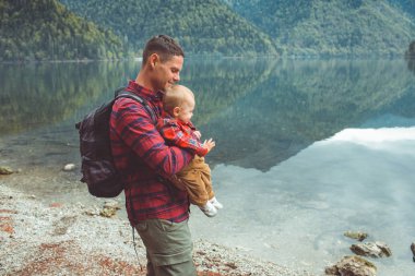 Dad and son walk by the lake