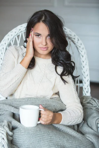 Woman in white armchair — 스톡 사진