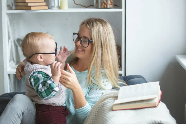 A woman and her son are reading