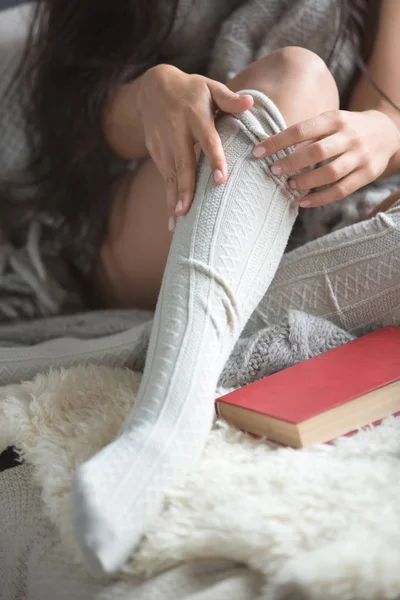 Legs in long knitted stockings — Stock Photo, Image