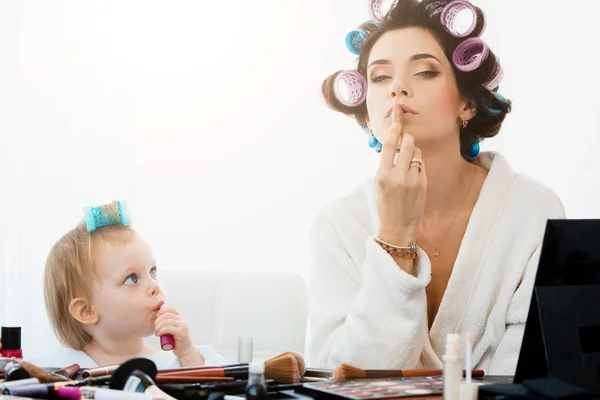 Mulher bonita e sua filha fazendo maquiagem — Fotografia de Stock