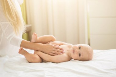 Mother making massage to her infant boy