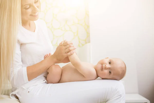Mother Making Massage Her Infant Boy Image En Vente