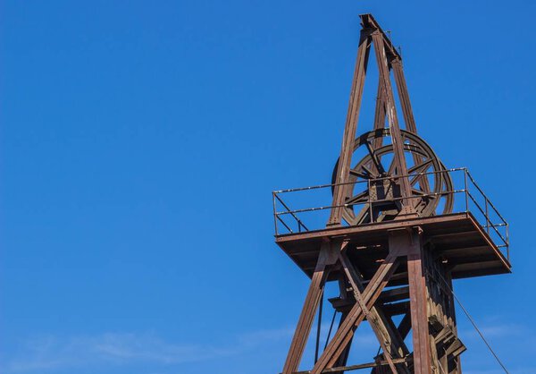 Vintage Rusted Mining Wheel & Tower In Sierra Foothills
