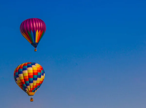 Dwa kolorowe balonów przeciwko niebieski niebo tło — Zdjęcie stockowe