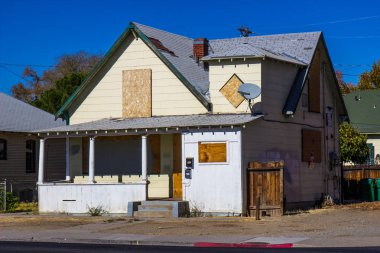 Old Boarded Up Home Lost To Foreclosure clipart