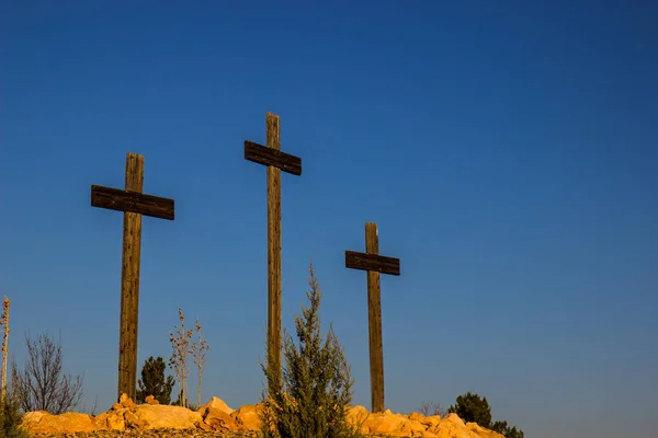 Three Wooden Crosses In Desert