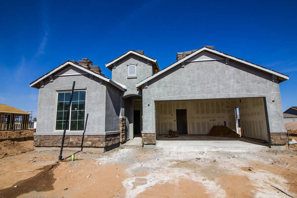New Home Under Construction With Stucco & Rock Work
