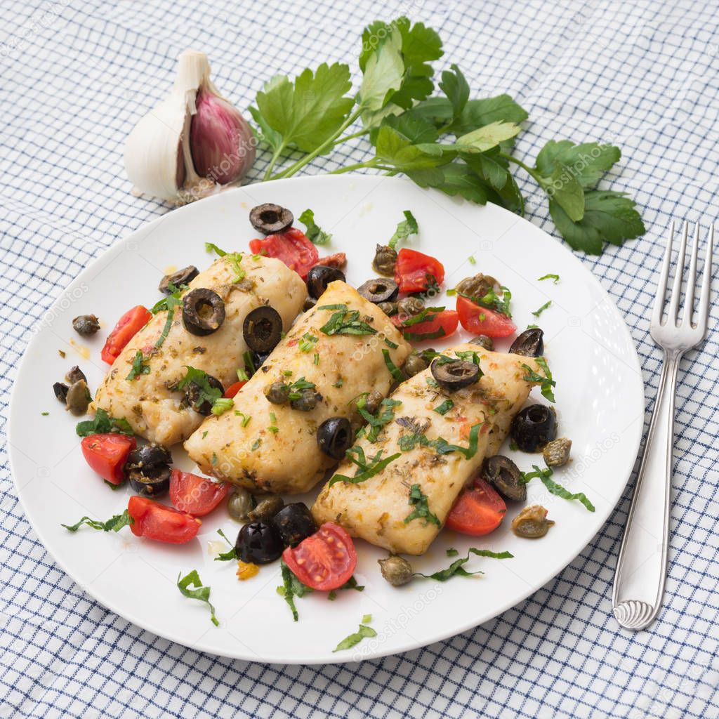 Cod fillets with black olives and tomato