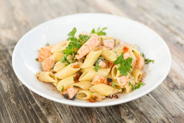 Dish of Italian Pasta with cooked salmon meat